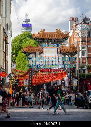 Crowds around Chinatown gate, London, with surrounding buildings and BT tower Stock Photo