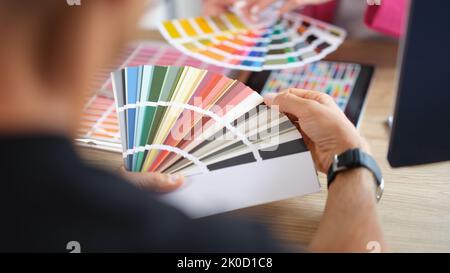 Hands of designers during the discussion and selection of colors for interior in studio Stock Photo