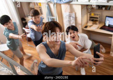 Young Chinese university students taking selfie in dormitory Stock Photo