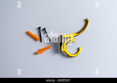 Wall hook hanger with dowels and screws on isolated white background Stock Photo