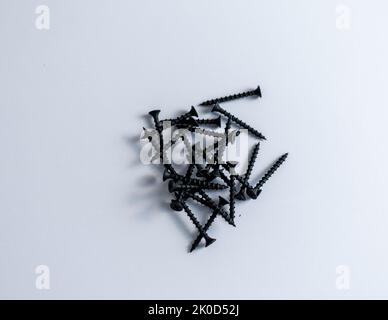 Pile of black screw on isolated white background Stock Photo