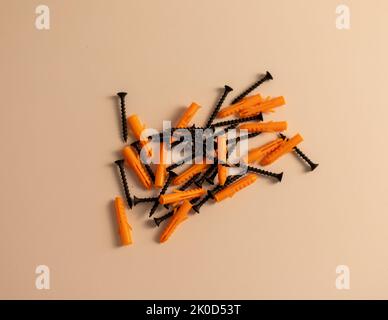 Black tapping screws with plastic dowels on isolated background Stock Photo
