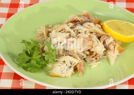 flaked smoked mackerel with lemon and arssley Stock Photo