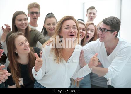 group of young people supporting their happy leader Stock Photo