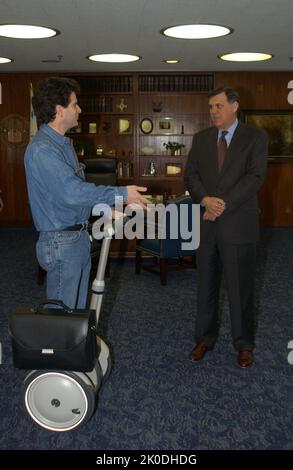 Secretary Mel Martinez, Staff Sampling Personal Transportation Device. Secretary Mel Martinez, Staff Sampling Personal Transportation Device Subject, Secretary Mel Martinez, other senior staff testing the Segway Human Transporter during visit to HUD Headquarters by the Segway's inventor, Dean Kamen. Stock Photo