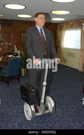 Secretary Mel Martinez, Staff Sampling Personal Transportation Device. Secretary Mel Martinez, Staff Sampling Personal Transportation Device Subject, Secretary Mel Martinez, other senior staff testing the Segway Human Transporter during visit to HUD Headquarters by the Segway's inventor, Dean Kamen. Stock Photo