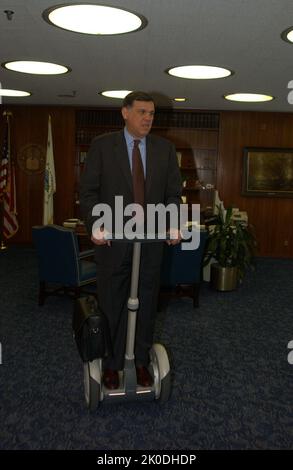 Secretary Mel Martinez, Staff Sampling Personal Transportation Device. Secretary Mel Martinez, Staff Sampling Personal Transportation Device Subject, Secretary Mel Martinez, other senior staff testing the Segway Human Transporter during visit to HUD Headquarters by the Segway's inventor, Dean Kamen. Stock Photo