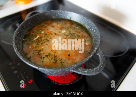 national soup in a cauldron on the stove Stock Photo