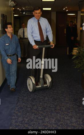 Secretary Mel Martinez, Staff Sampling Personal Transportation Device. Secretary Mel Martinez, Staff Sampling Personal Transportation Device Subject, Secretary Mel Martinez, other senior staff testing the Segway Human Transporter during visit to HUD Headquarters by the Segway's inventor, Dean Kamen. Stock Photo