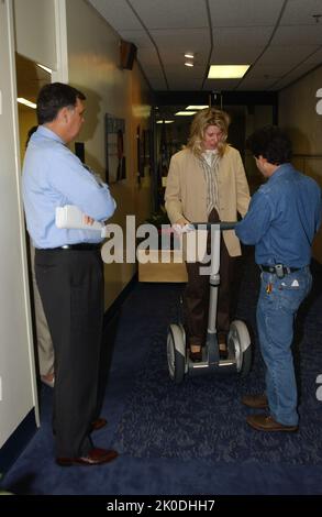 Secretary Mel Martinez, Staff Sampling Personal Transportation Device. Secretary Mel Martinez, Staff Sampling Personal Transportation Device Subject, Secretary Mel Martinez, other senior staff testing the Segway Human Transporter during visit to HUD Headquarters by the Segway's inventor, Dean Kamen. Stock Photo