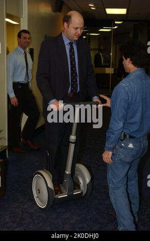 Secretary Mel Martinez, Staff Sampling Personal Transportation Device. Secretary Mel Martinez, Staff Sampling Personal Transportation Device Subject, Secretary Mel Martinez, other senior staff testing the Segway Human Transporter during visit to HUD Headquarters by the Segway's inventor, Dean Kamen. Stock Photo