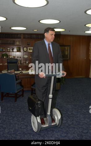 Secretary Mel Martinez, Staff Sampling Personal Transportation Device. Secretary Mel Martinez, Staff Sampling Personal Transportation Device Subject, Secretary Mel Martinez, other senior staff testing the Segway Human Transporter during visit to HUD Headquarters by the Segway's inventor, Dean Kamen. Stock Photo