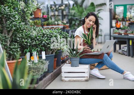 Woman working in a garden center Stock Photo