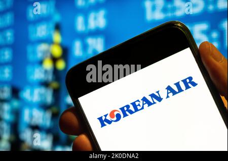 In this photo illustration, the largest airline and flag carrier of South Korea, Korean Air, logo is displayed on a smartphone screen. Stock Photo