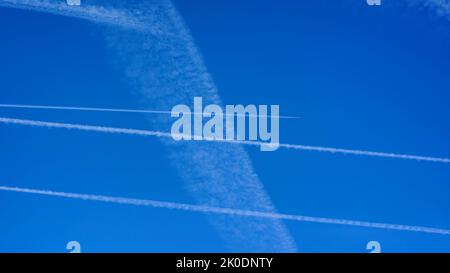Blue sky with aircraft condensation trails. Stock Photo