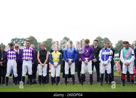 Jockey’s hold a 2 minutes silence following the death of Queen Elizabeth II on Thursday of at Doncaster Racecourse. Picture date: Sunday September 11, 2022. Stock Photo