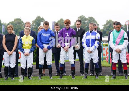 Jockey’s hold a 2 minutes silence following the death of Queen Elizabeth II on Thursday of at Doncaster Racecourse. Picture date: Sunday September 11, 2022. Stock Photo