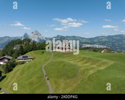 Fronalpstock Klingenstock wooden chapel in Stoos in central Switzerland a small wintersport ski resort village. Grassland alps alpine town on a clear Stock Photo