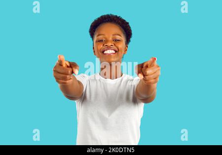 Happy young African American woman looking at camera, pointing at you and smiling Stock Photo