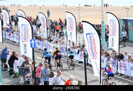 Brighton UK 11th September 2022 - Riders taking part in the London to Brighton Cycle Ride near the finishing line on the seafront . The ride is in aid of many charities including the Great Ormond Street Hospital ChildrenÕs Charity : Credit Simon Dack / Alamy Live News Stock Photo