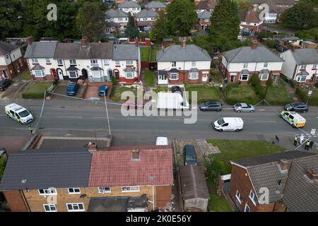 Newbury Lane, Oldbury, England - September 11th 2022 - The Wolverhampton Road Crime Scene - West Midlands Police are investigating an attempted murder on Newbury Lane in Oldbury where a 32-year-old man was stabbed, leaving him critically injured. Officers cordoned off a row of housing where the attack took place. One house was also manned by officers. Around a quarter of a mile from the scene, police also closed part of the Wolverhampton Road where a Mercedes vehicle had crashed near an Esso garage. Stock Photo