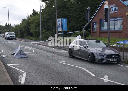 Wolverhampton Road, Oldbury, England - September 11th 2022 - The Wolverhampton Road Crime Scene - West Midlands Police are investigating an attempted murder on Newbury Lane in Oldbury where a 32-year-old man was stabbed, leaving him critically injured. Officers cordoned off a row of housing where the attack took place. One house was also manned by officers. Around a quarter of a mile from the scene, police also closed part of the Wolverhampton Road where a Mercedes vehicle had crashed near an Esso garage. Stock Photo