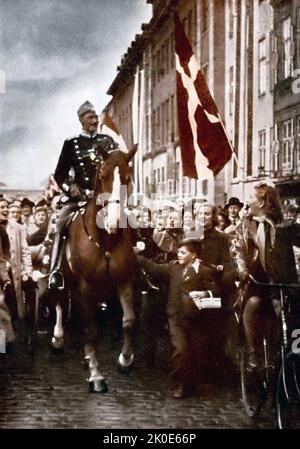 King Christian X of Denmark, riding through Copenhagen on his 70th birthday, 1940. The picture was taken during the German occupation of Denmark, in World War II. Stock Photo
