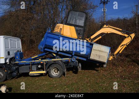 A tow truck loads a broken down machine Stock Photo