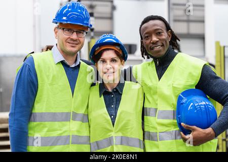 Team of engineers working inside robotic factory - Industry concept Stock Photo