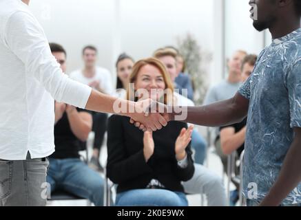 young opponents shake hands before the start of the briefing Stock Photo