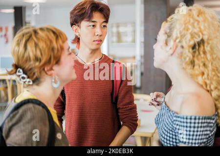 Students standing together in the university library Stock Photo