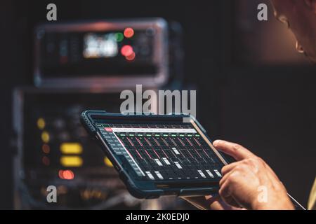 Remote control and sound settings from the tablet. Stock Photo