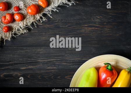 Vegetable on wooden table background, top view of organic whole food. Sweet pepper, zucchini and small tomatoes on wood rustic planks with space, flat Stock Photo