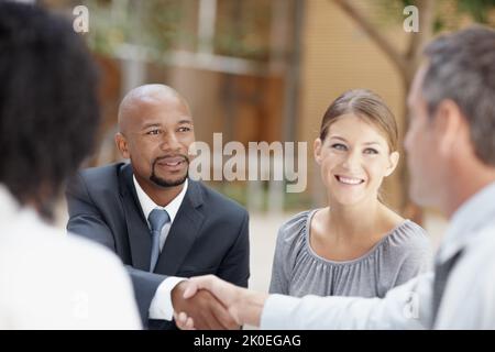 It was nice meeting you. Two businessmen shaking hands during a meeting. Stock Photo
