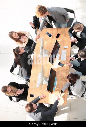 top view. happy employees shaking hands during a meeting Stock Photo