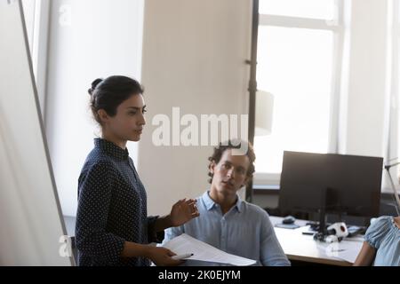 Confident young Indian business leader woman presenting project Stock Photo