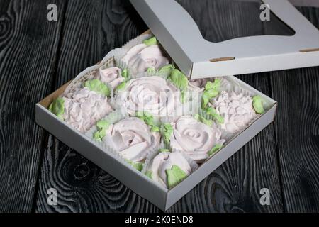 Zephyr flowers. Zephyr in a cardboard box. On pine boards. Stock Photo