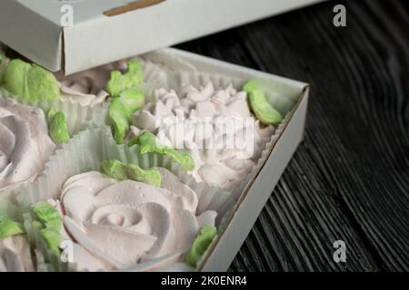 Zephyr flowers. Zephyr in a cardboard box. On pine boards. Close-up. Stock Photo