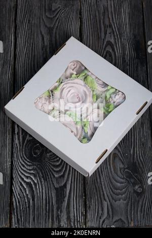 Zephyr flowers. Zephyr in a cardboard box. On pine boards. Stock Photo