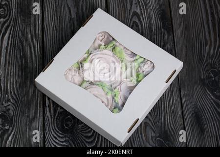 Zephyr flowers. Zephyr in a cardboard box. On pine boards. Stock Photo