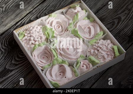 Zephyr flowers. Zephyr in a cardboard box. On pine boards. Stock Photo
