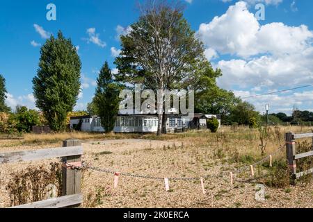 Closed and overgrown car park of The Winch, a closed down public house in West Winch, Norfolk. Stock Photo
