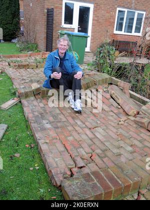 SITTING ON THE FENCE. ALAN CRAVEN OPF THE KEEP, PORTCHESTER SITS ON HIS GARDEN WALL WHICH WAS BLOWN DOWN IN THW STORM. PIC MIKE WALKER,2013 MIKE WALKER PICTURES Stock Photo