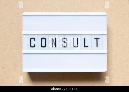 Lightbox with word consult on wood background Stock Photo