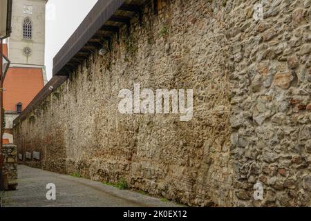 A road next to the surrounding wall of the old city of Bratislava Stock Photo
