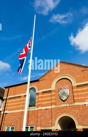 The Union Flag flies at half mast to mark the passing of HM Queen Elizabeth II at the Town Hall, Grantham, Lincolnshire, England. 11th September 2022 Stock Photo