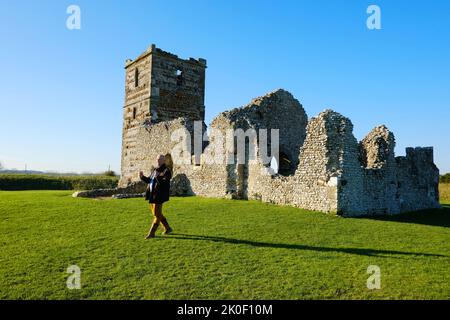 Adult male dowsing the ley lines at Knowlton Church, Dorset, UK - John Gollop Stock Photo