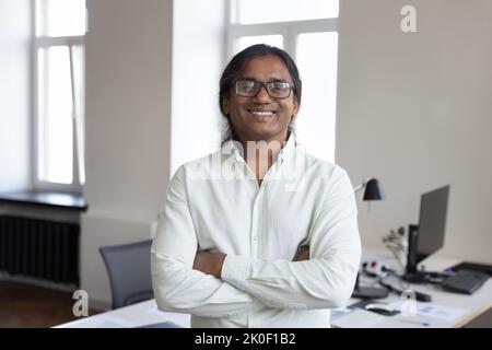 Happy confident Indian business man in glasses head shot portrait Stock Photo