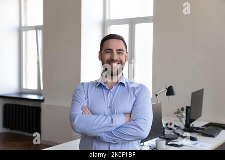 Happy handsome businessman looking at camera, smiling posing Stock Photo