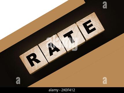 Rate word concept written on wooden cubes blocks lying on a black background. Business services rating concept. Stock Photo